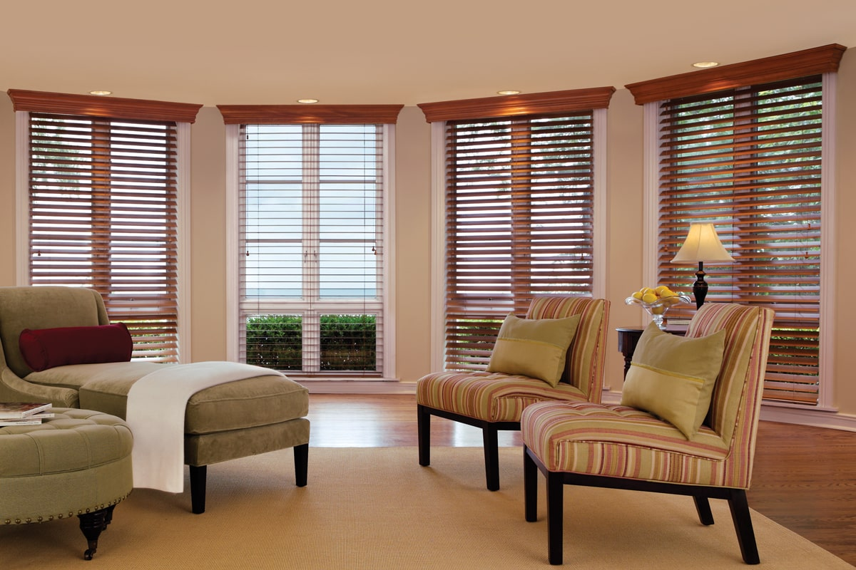 A living room filled with furniture and windows covered in blinds